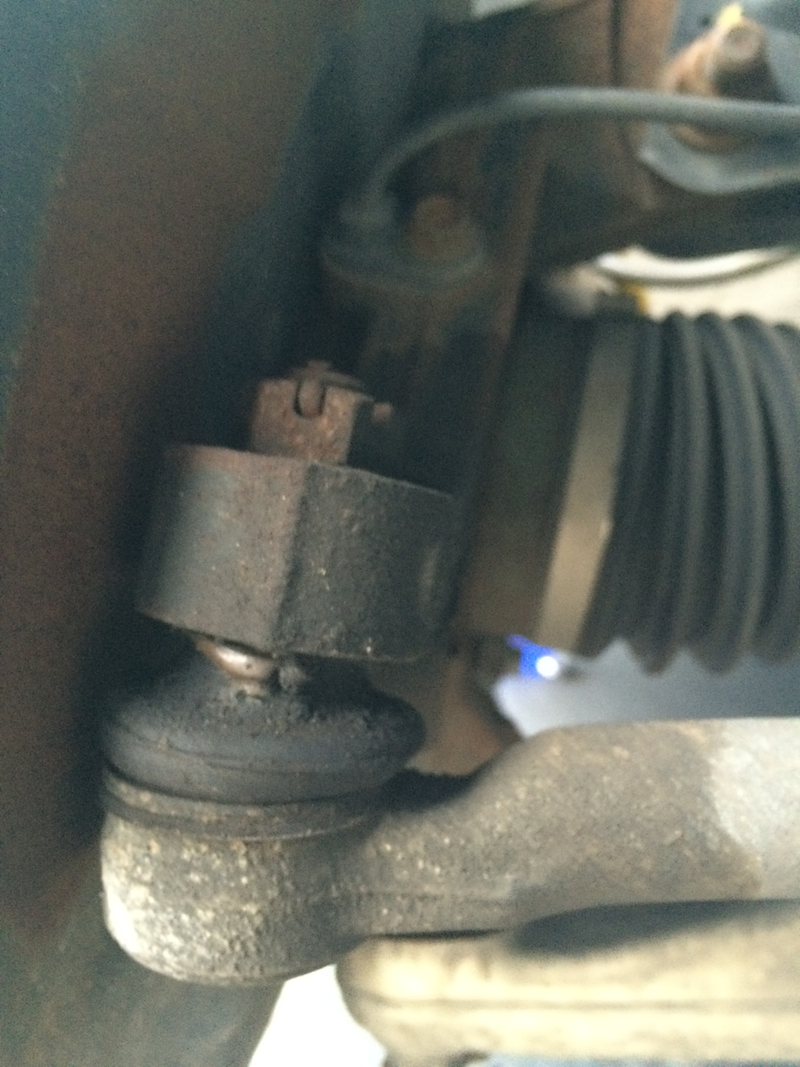 Tie rod end, with a broken boot puking grease.